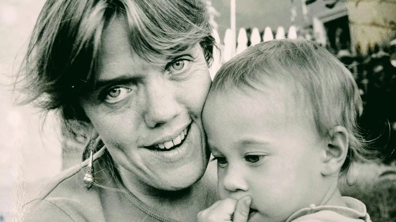 Black-and-white photo of a young Meg Weber holding her baby